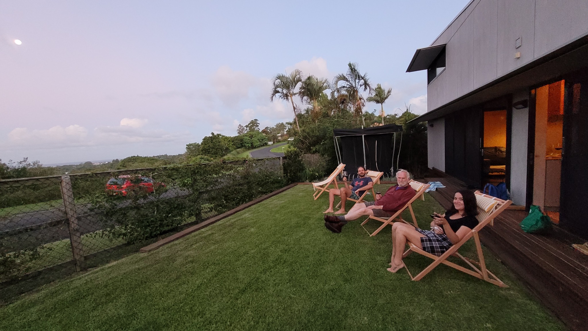People relaxing on the lawn in the evening